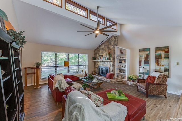 8537 Classic Oaks Ln, San Antonio, TX 78255 - living room with high vaulted ceiling, wood finished floors, a ceiling fan, a fireplace, and baseboards