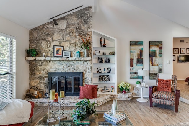 8537 Classic Oaks Ln, San Antonio, TX 78255 - living area with wood finished floors, a stone fireplace, high vaulted ceiling, and baseboards