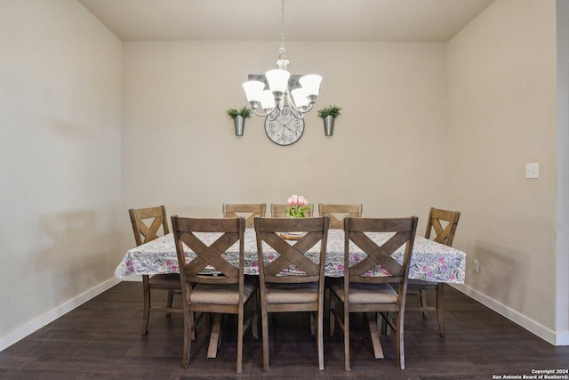 7718 Blue Gulf, San Antonio, TX 78222 - dining area featuring a chandelier, baseboards, and wood finished floors