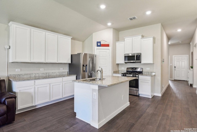 7718 Blue Gulf, San Antonio, TX 78222 - kitchen featuring appliances with stainless steel finishes, a sink, white cabinets, vaulted ceiling, and light stone countertops