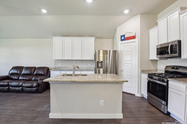 7718 Blue Gulf, San Antonio, TX 78222 - kitchen with stainless steel appliances, a sink, open floor plan, vaulted ceiling, and light stone counters