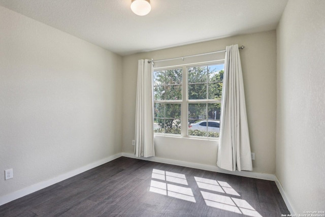 7718 Blue Gulf, San Antonio, TX 78222 - spare room with dark wood-type flooring and baseboards