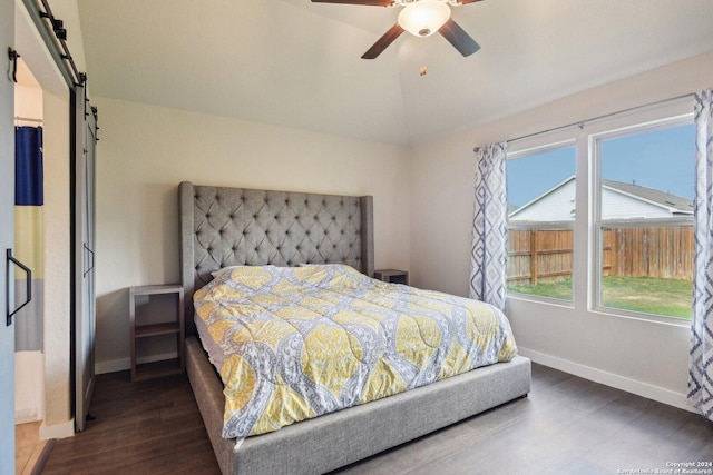 7718 Blue Gulf, San Antonio, TX 78222 - bedroom featuring wood finished floors, baseboards, lofted ceiling, a barn door, and ceiling fan
