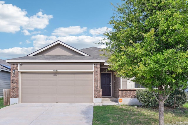 7718 Blue Gulf, San Antonio, TX 78222 - view of front of property featuring brick siding, driveway, an attached garage, and a shingled roof