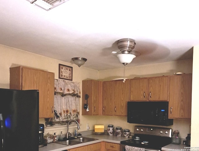 210 Catherine, San Antonio, TX 78237 - kitchen featuring black appliances, a sink, and brown cabinetry