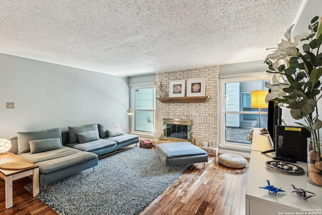 2300 Nacogdoches Rd Unit 164R, San Antonio, TX 78209 - living area with wood finished floors, a textured ceiling, and a brick fireplace