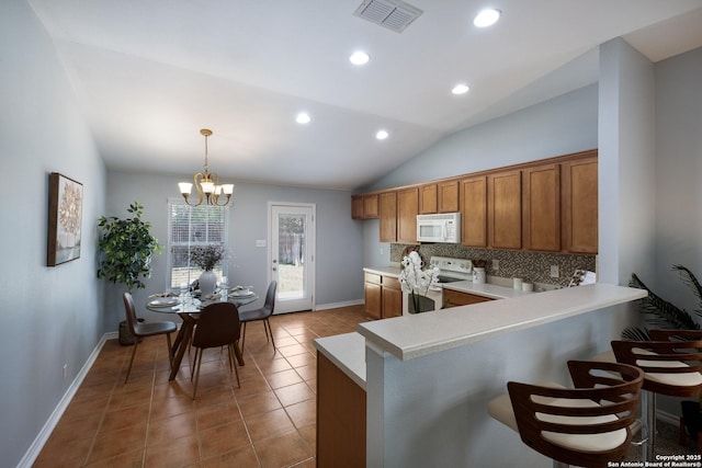 9911 Sable Arrow, San Antonio, TX 78251 - kitchen featuring white appliances, brown cabinets, light countertops, lofted ceiling, and a chandelier