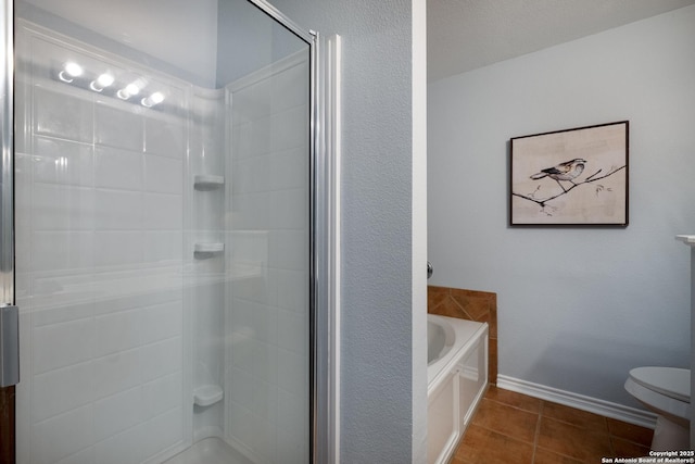 9911 Sable Arrow, San Antonio, TX 78251 - bathroom with a shower stall, toilet, a garden tub, tile patterned floors, and baseboards
