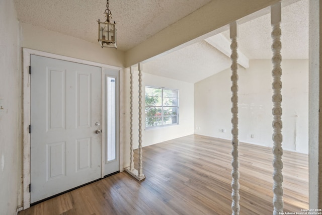 1324 Longmont, San Antonio, TX 78245 - entryway featuring wood finished floors, a textured ceiling, and a chandelier