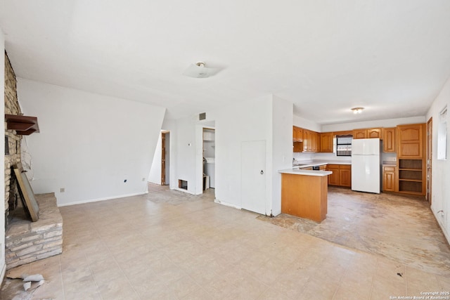 771 Mockingbird, Spring Branch, TX 78070 - unfurnished living room with a large fireplace, washer / dryer, and light floors