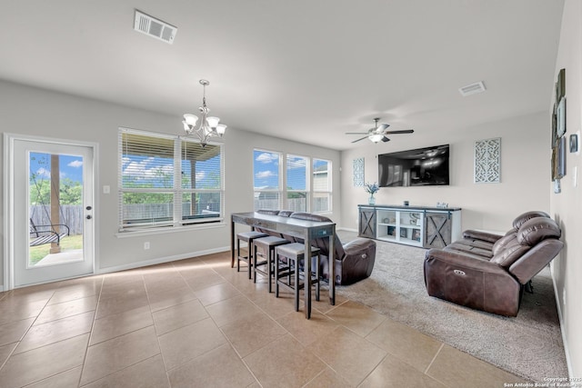 7702 Bit Cir, Elmendorf, TX 78112 - tiled living area with healthy amount of natural light, a chandelier, baseboards, and ceiling fan