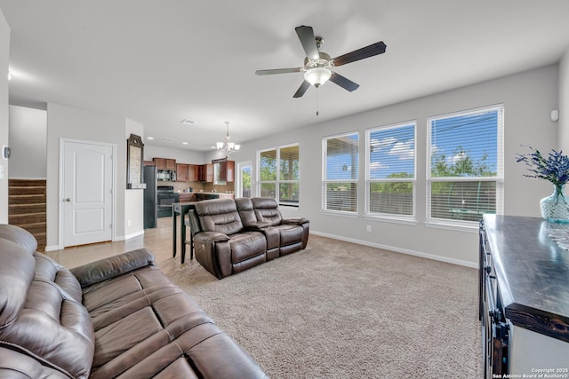 7702 Bit Cir, Elmendorf, TX 78112 - living area featuring a chandelier, baseboards, ceiling fan, stairs, and light carpet