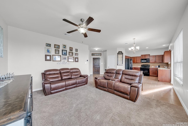 7702 Bit Cir, Elmendorf, TX 78112 - living room featuring a chandelier, a ceiling fan, light carpet, recessed lighting, and baseboards