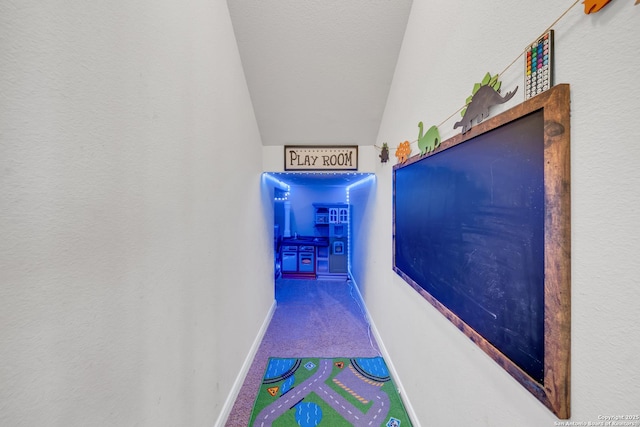 7702 Bit Cir, Elmendorf, TX 78112 - hall with carpet, baseboards, and vaulted ceiling