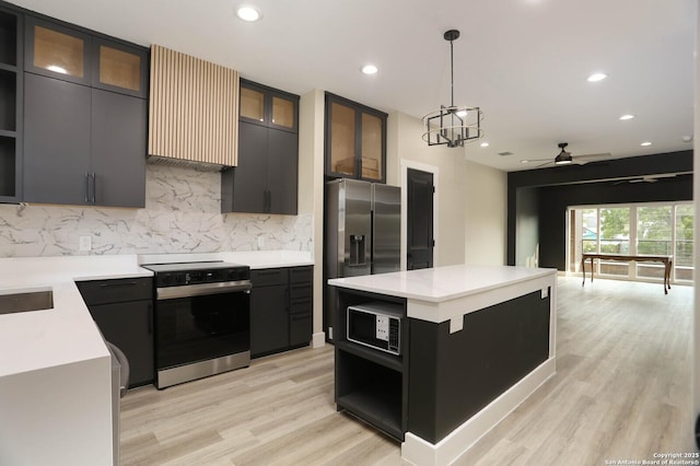 130 E Lachapelle, San Antonio, TX 78204 - kitchen featuring electric range, backsplash, light countertops, light wood finished floors, and recessed lighting