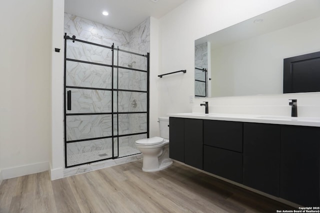 130 E Lachapelle, San Antonio, TX 78204 - bathroom with toilet, double vanity, a stall shower, and wood finished floors