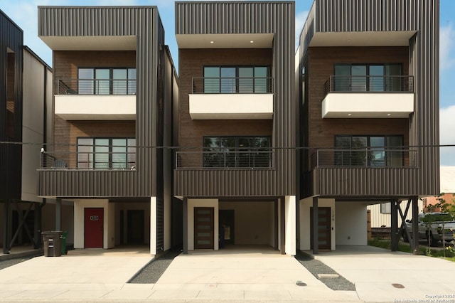 130 E Lachapelle, San Antonio, TX 78204 - view of building exterior featuring a carport, driveway, and stairs