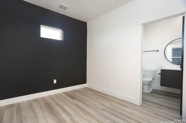 130 E Lachapelle, San Antonio, TX 78204 - unfurnished bedroom with light wood-type flooring, baseboards, and ensuite bath