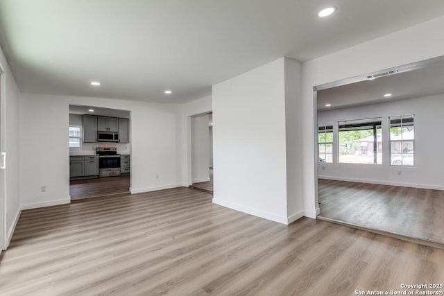 602 John Page, San Antonio, TX 78228 - unfurnished living room featuring light wood-style flooring, recessed lighting, and baseboards