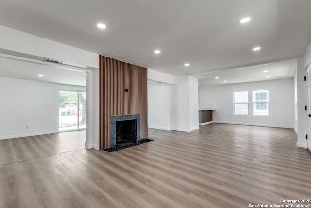 602 John Page, San Antonio, TX 78228 - unfurnished living room with plenty of natural light, wood finished floors, recessed lighting, a fireplace, and baseboards