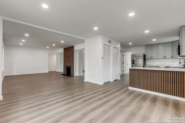 602 John Page, San Antonio, TX 78228 - kitchen featuring stainless steel appliances, gray cabinets, a sink, open floor plan, and baseboards
