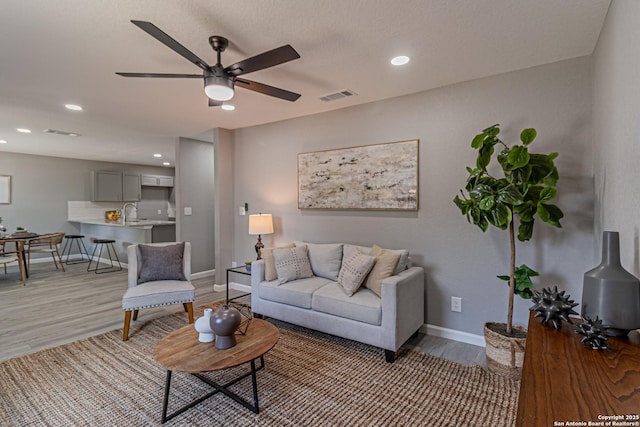 4935 Bartmer Ave, San Antonio, TX 78228 - living area with light wood-style flooring, a ceiling fan, and recessed lighting