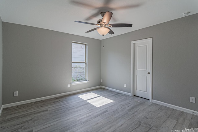 4935 Bartmer Ave, San Antonio, TX 78228 - empty room with ceiling fan, wood finished floors, and a smoke detector