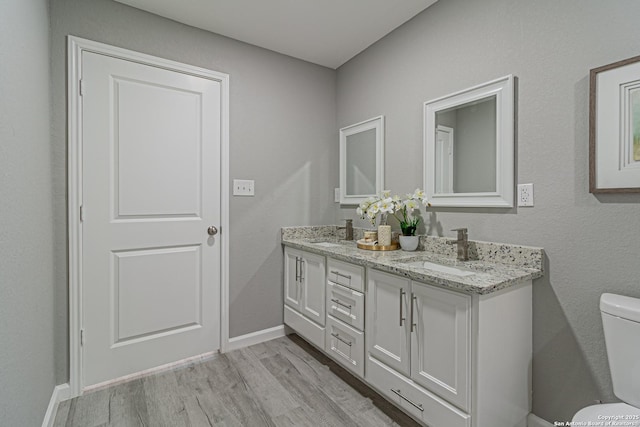 4935 Bartmer Ave, San Antonio, TX 78228 - bathroom featuring wood finished floors and double vanity