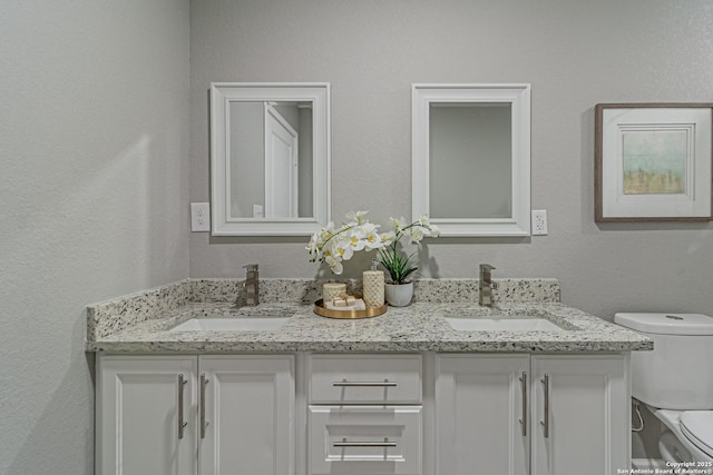 4935 Bartmer Ave, San Antonio, TX 78228 - full bath featuring double vanity and a textured wall