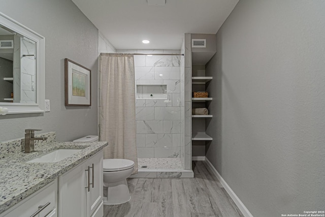 4935 Bartmer Ave, San Antonio, TX 78228 - full bath with wood finished floors, vanity, and a shower stall