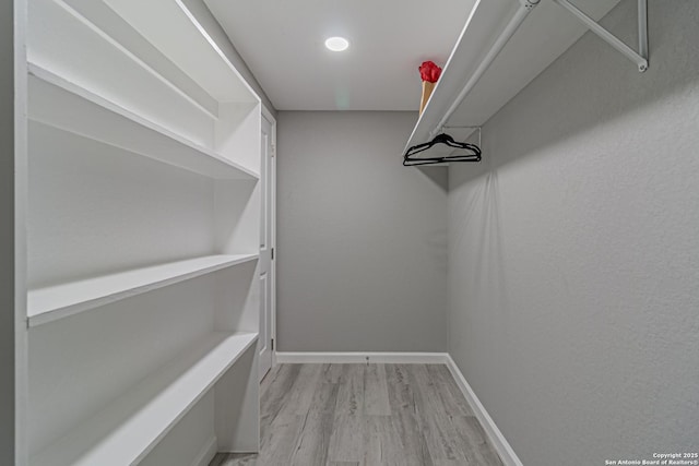 4935 Bartmer Ave, San Antonio, TX 78228 - walk in closet featuring light wood-type flooring