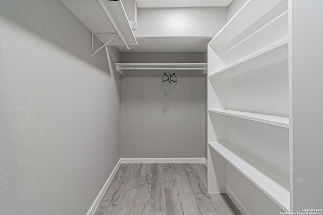 4935 Bartmer Ave, San Antonio, TX 78228 - walk in closet with wood finished floors