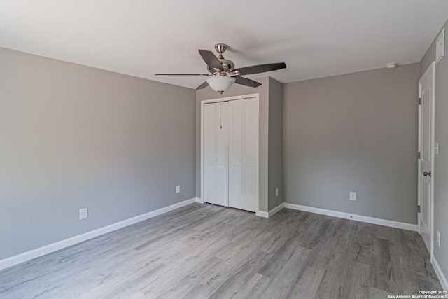 4935 Bartmer Ave, San Antonio, TX 78228 - unfurnished bedroom with wood finished floors, a closet, and ceiling fan