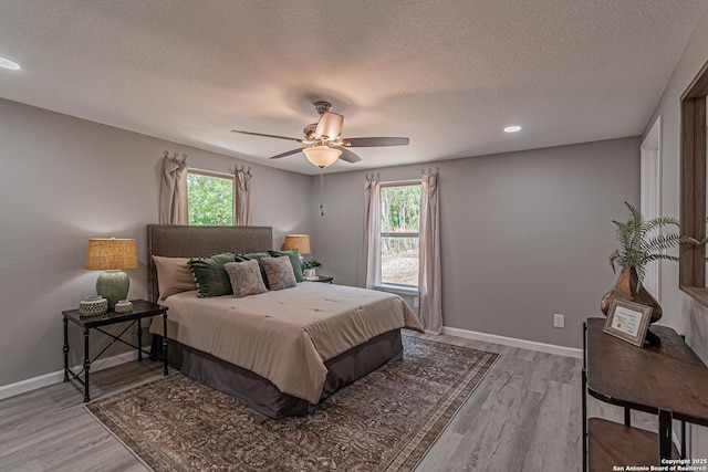 4935 Bartmer Ave, San Antonio, TX 78228 - bedroom featuring light wood-type flooring, a textured ceiling, a ceiling fan, and recessed lighting