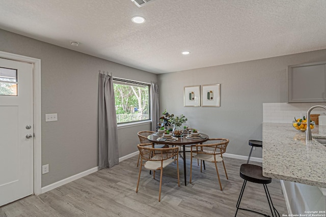 4935 Bartmer Ave, San Antonio, TX 78228 - dining area featuring a textured ceiling, light wood-type flooring, and recessed lighting