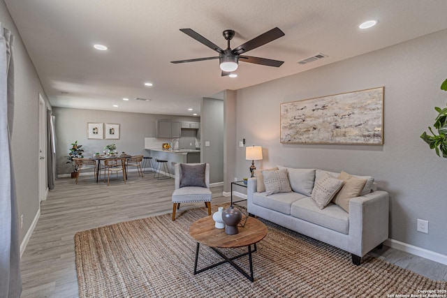 4935 Bartmer Ave, San Antonio, TX 78228 - living room with light wood finished floors, a ceiling fan, and recessed lighting