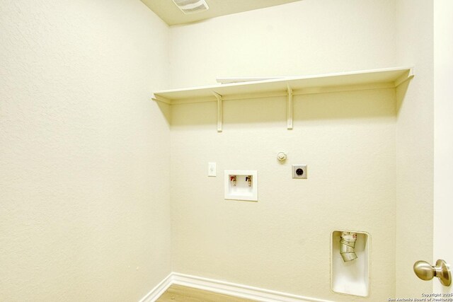 13351 Welsh Pony, San Antonio, TX 78254 - laundry room featuring washer hookup, electric dryer hookup, baseboards, light wood-type flooring, and hookup for a gas dryer