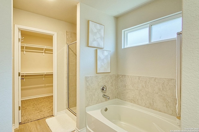 13351 Welsh Pony, San Antonio, TX 78254 - bathroom featuring a garden tub, a stall shower, a walk in closet, and wood finished floors