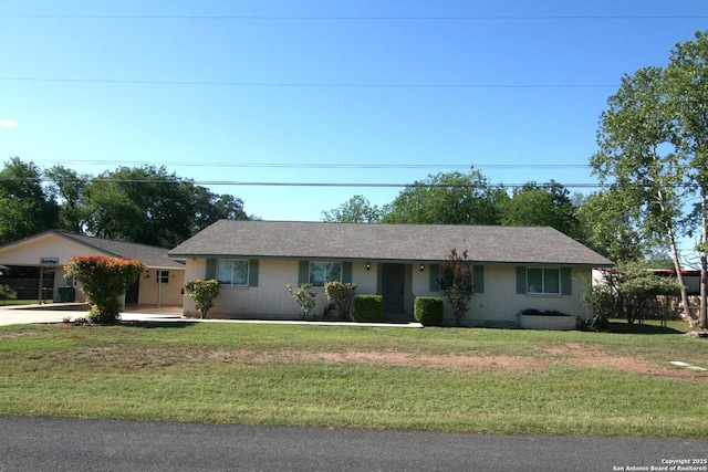 206 Alvina, Castroville, TX 78009 - ranch-style home featuring a front lawn, concrete driveway, and brick siding
