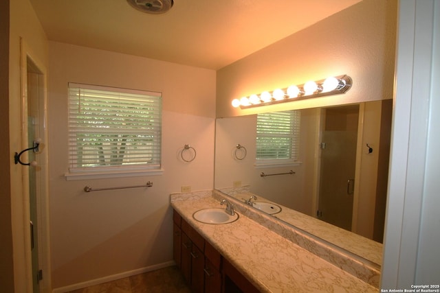 206 Alvina, Castroville, TX 78009 - bathroom featuring vanity, a stall shower, and baseboards