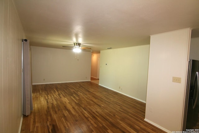 206 Alvina, Castroville, TX 78009 - unfurnished room featuring dark wood-style flooring, a ceiling fan, and baseboards