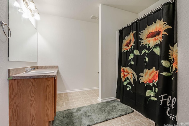 5439 Kensington Run, San Antonio, TX 78228 - bathroom featuring vanity, tile patterned flooring, a shower with shower curtain, and baseboards