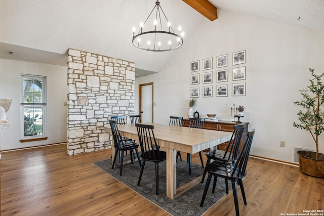 101 Country Ln, Castroville, TX 78009 - dining area featuring beam ceiling, a chandelier, wood finished floors, high vaulted ceiling, and baseboards