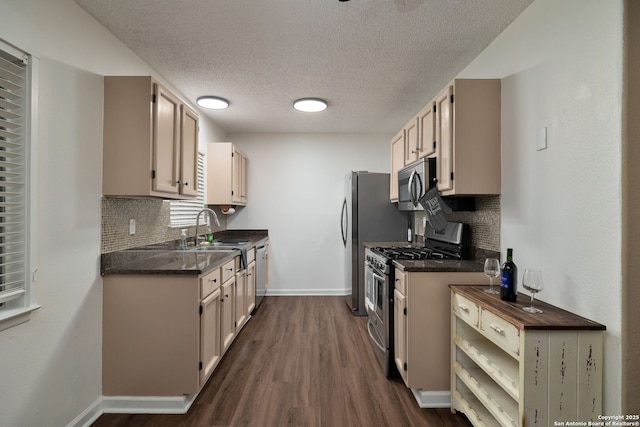 5954 Lost Crk, San Antonio, TX 78247 - kitchen with appliances with stainless steel finishes, a sink, baseboards, dark wood-style floors, and a textured ceiling