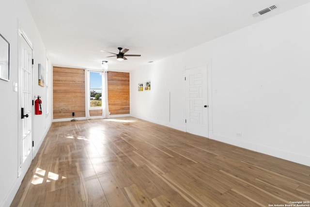 30951 Blanco Rd, Bulverde, TX 78163 - empty room with a ceiling fan, wood finished floors, baseboards, and wooden walls