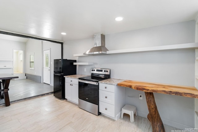 30951 Blanco Rd, Bulverde, TX 78163 - kitchen with stainless steel electric range oven, freestanding refrigerator, white cabinetry, wall chimney range hood, and open shelves