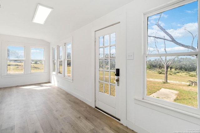 30951 Blanco Rd, Bulverde, TX 78163 - unfurnished sunroom with lofted ceiling, wood finished floors, and plenty of natural light