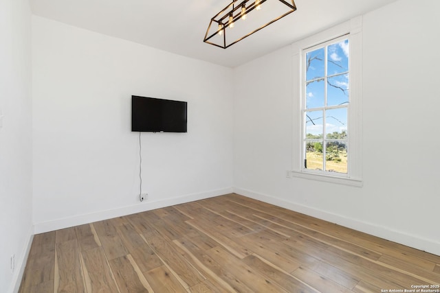 30951 Blanco Rd, Bulverde, TX 78163 - spare room featuring a chandelier, baseboards, and wood-type flooring