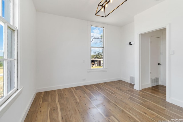 30951 Blanco Rd, Bulverde, TX 78163 - empty room featuring light wood-type flooring, baseboards, and a chandelier