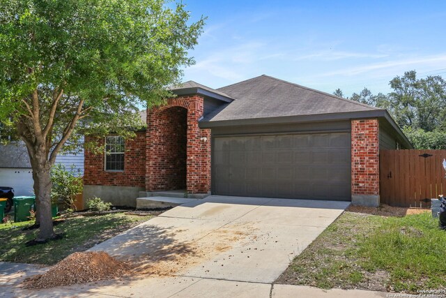 9814 Shawnee, Converse, TX 78109 - single story home featuring brick siding, an attached garage, concrete driveway, and a shingled roof